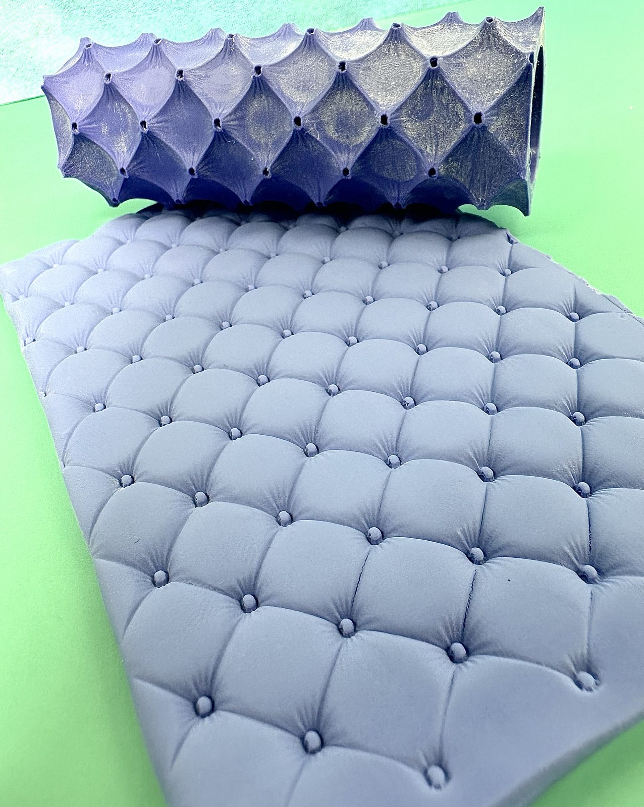 Quilted cushion texture roller pressed into periwinkle polymer clay